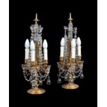 A pair of gilt brass and four light candelabra fitted as table lamps