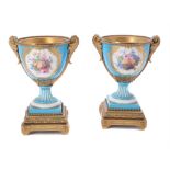 A pair of French porcelain Sevres-style gilt-metal mounted urns