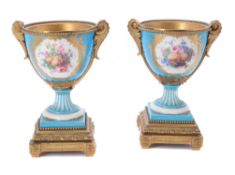 A pair of French porcelain Sevres-style gilt-metal mounted urns