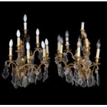 A pair of gilt metal and cut glass six branch wall appliques in Louis XV style