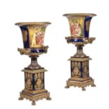 A pair of modern Sevres-style porcelain and gilt metal mounted campana urns and stands