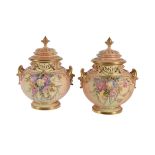 A pair of Royal Worcester ivory-ground pot-pourri urns and covers signed and painted with flowers by