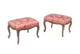 A pair of carved giltwood and tinted stools