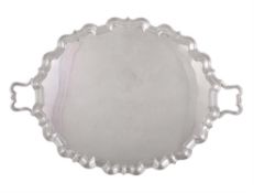 A silver twin handled shaped oval tray by Thomas Bradbury & Sons Ltd