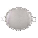 A silver twin handled shaped oval tray by Thomas Bradbury & Sons Ltd