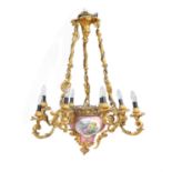 A Napoleon III gilt bronze and Sevres-style porcelain nine light chandelier