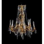 A French gilt metal and cut glass twelve light chandelier in Louis XVI style