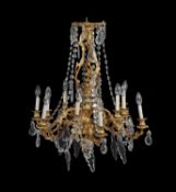 A French gilt metal and cut glass twelve light chandelier in Louis XVI style