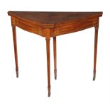 An Edwardian mahogany and marquetry shaped triangular card table