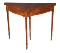 An Edwardian mahogany and marquetry shaped triangular card table