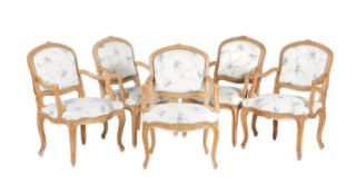 A set of ten carved beech wood elbow chairs