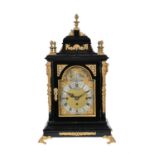An Edwardian ebonised and gilt-metal mounted quarter chiming bracket clock
