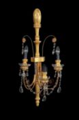 A set of four giltwood and gesso three branch wall lights