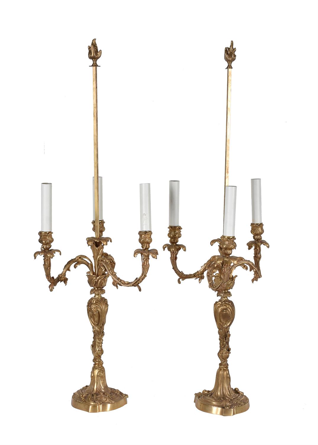 A pair of French gilt bronze Rococo Revival three-branch candelabra