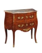 A walnut, marquetry inlaid, and gilt metal mounted commode in the Louis XV style