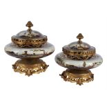 A pair of French porcelain and gilt metal mounted potpourri urns and covers