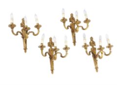 A set of ten gilt metal three light wall appliques in Louis XVI taste