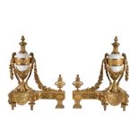 A pair of French gilt bronze and white marble mounted chenets in Louis XVI style