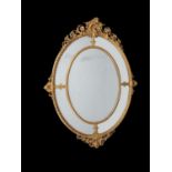 A French carved giltwood oval marginal wall mirror