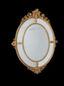 A French carved giltwood oval marginal wall mirror