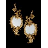 A pair of carved giltwood girandoles in the George II style