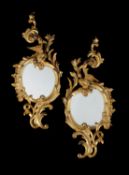 A pair of carved giltwood girandoles in the George II style