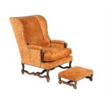 A walnut and cut velvet upholstered wing armchair in the Continental 18th Century style