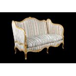 A French carved giltwood sofa in Louis XV style