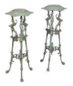 A pair of French cast iron and green enamel low torcheres in early 19th Century style