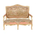 A French carved giltwood and upholstered settee in the Louis XV style