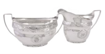 A George III silver oval sugar basin and cream jug