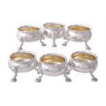 A matched set of six late George II silver cauldron salt cellars