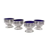 A set of four George IIII silver oval pedestal salt cellars by Robert Hennell I