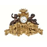A late 19th century French ormolu and patinated bronze clock in the Louis XV style