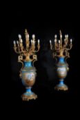 A substantial pair of Sevres-style porcelain gilt-metal-mounted floor vases fitted as lamps