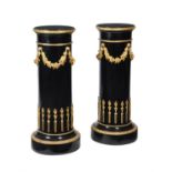 A pair of French ebonised and gilt bronze mounted pedestals