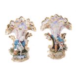 A pair of French biscuit and glazed porcelain figural frill vases