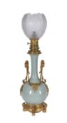 A French celadon glazed porcelain and gilt metal mounted oil lamp