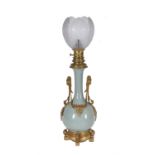 A French celadon glazed porcelain and gilt metal mounted oil lamp
