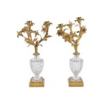 A pair of gilt metal and cut glass two light candelabra