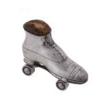 An Edwardian silver novelty roller skate pin cushion