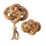 A mid Victorian foiled emerald and gold lovers knot brooch