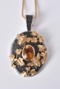 An 18 carat gold citrine, diamond and black diamond locket pendant by Theo Fennell