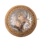 A mid Victorian reverse painted intaglio brooch