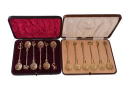 Two cased sets of six silver and silver gilt coloured tea spoons