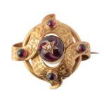 A mid Victorian gold and garnet knot brooch