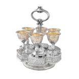 A Victorian silver shaped circular egg cup stand and six egg cups by Henry Wilkinson & Co.