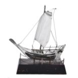 A silver coloured model of a dhow