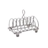 A George IV silver six division toast rack by John & Thomas Settle, Gunn & Co.