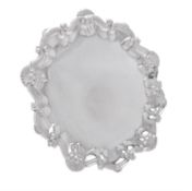 An Edwardian silver shaped circular salver by Barker Brothers